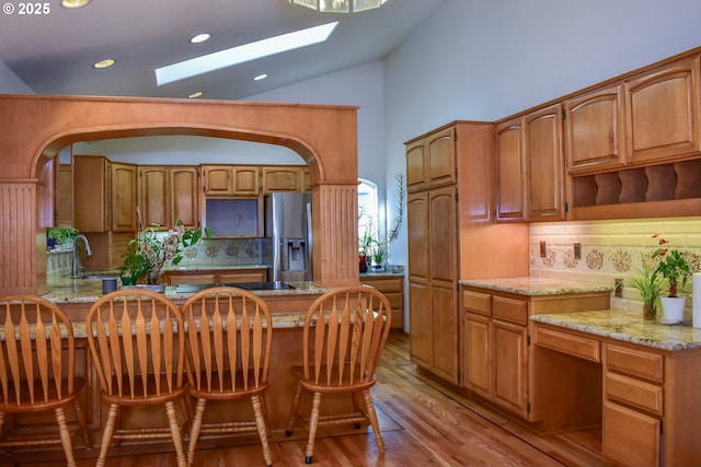 130 Candice Ct, Medford, OR 97504 - kitchen featuring stainless steel fridge with ice dispenser, light hardwood / wood-style flooring, light stone countertops, and sink