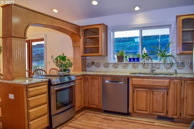 130 Candice Ct, Medford, OR 97504 - kitchen with appliances with stainless steel finishes, sink, light stone counters, and light wood-type flooring