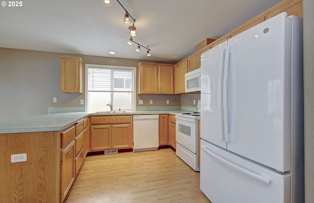 kitchen with light countertops, visible vents, a sink, light wood-type flooring, and white appliances