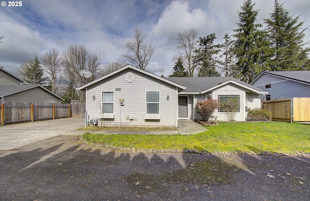 view of front of property with fence and a front lawn