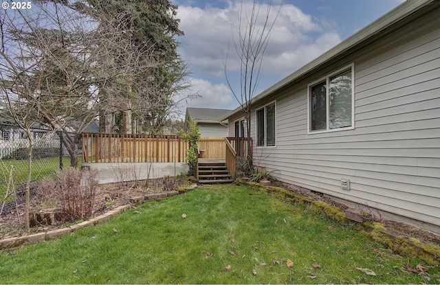 view of yard with a fenced backyard and a deck