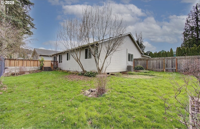 exterior space featuring central AC unit, a lawn, a fenced backyard, and a wooden deck