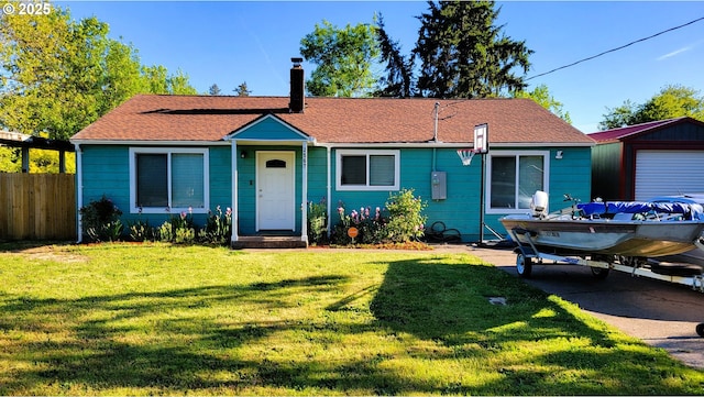 ranch-style home featuring a front lawn, fence, roof with shingles, and a chimney