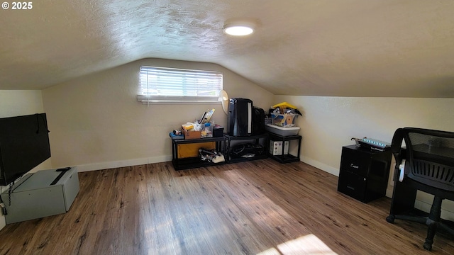 home office with lofted ceiling, baseboards, and wood finished floors