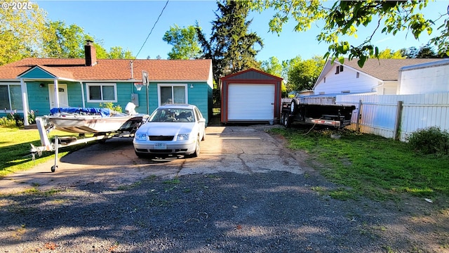 view of front of property featuring fence, a storage shed, a chimney, and an outdoor structure