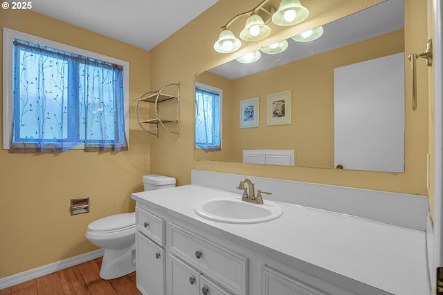 5786 SW 204th Pl, Beaverton, OR 97078 - bathroom featuring toilet, baseboards, vanity, and wood finished floors