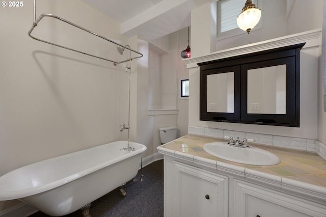 full bathroom with vanity, baseboards, a shower, and a freestanding tub