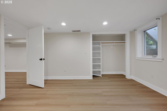unfurnished bedroom with a closet, visible vents, recessed lighting, light wood-style flooring, and baseboards