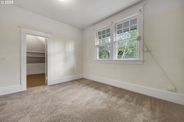 spare room featuring baseboards and carpet floors