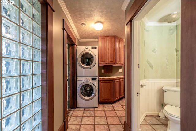 619 S 11th St, Coos Bay, OR 97420 - laundry area with estacked washer and dryer, cabinet space, crown molding, a wainscoted wall, and light stone finish floors