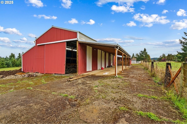 view of pole building with fence