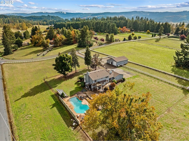 view of rural area featuring a pool and a mountain backdrop