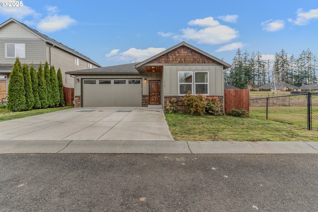 view of front of property with a garage and a front lawn