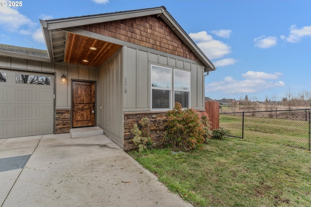 exterior space featuring a garage and a lawn