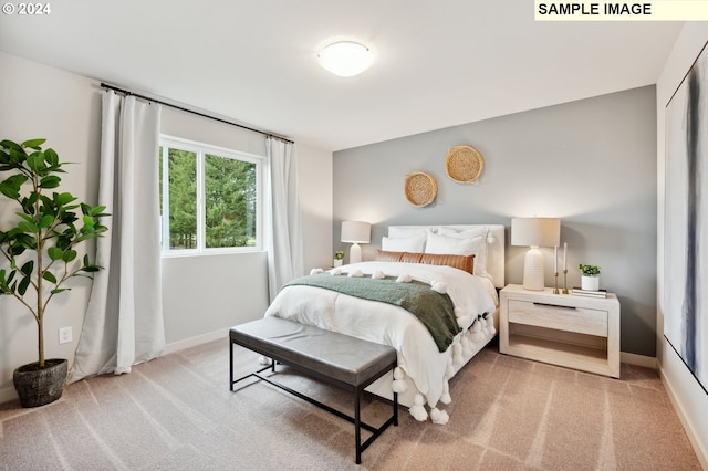 bedroom featuring light colored carpet