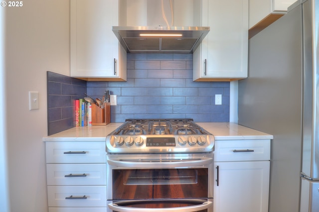 95660 Spirit Ridge Rd, Gold Beach, OR 97444 - kitchen with exhaust hood, appliances with stainless steel finishes, white cabinetry, tasteful backsplash, and light stone counters