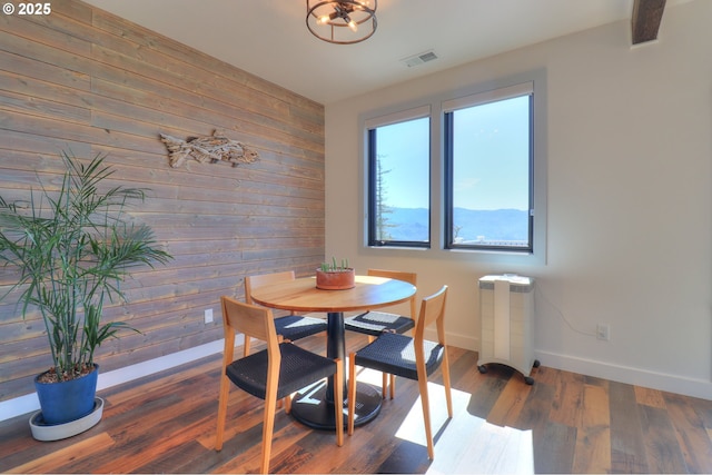 95660 Spirit Ridge Rd, Gold Beach, OR 97444 - dining room featuring wood walls, baseboards, and wood finished floors