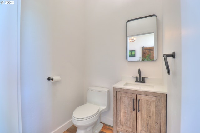 95660 Spirit Ridge Rd, Gold Beach, OR 97444 - bathroom featuring toilet, vanity, baseboards, and wood finished floors
