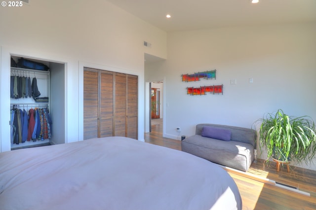 95660 Spirit Ridge Rd, Gold Beach, OR 97444 - bedroom featuring multiple closets, wood finished floors, recessed lighting, high vaulted ceiling, and baseboards