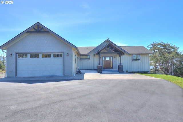 95660 Spirit Ridge Rd, Gold Beach, OR 97444 - view of front facade with board and batten siding, an attached garage, and driveway