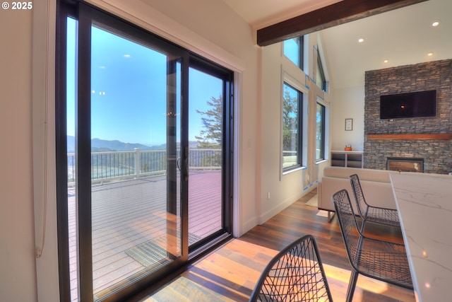 95660 Spirit Ridge Rd, Gold Beach, OR 97444 - entryway featuring wood finished floors, a fireplace, baseboards, beam ceiling, and recessed lighting