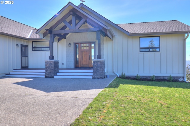 95660 Spirit Ridge Rd, Gold Beach, OR 97444 - view of front of home featuring board and batten siding, a shingled roof, and a front yard