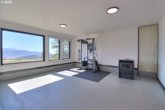 95660 Spirit Ridge Rd, Gold Beach, OR 97444 - exercise room with a wood stove and baseboards