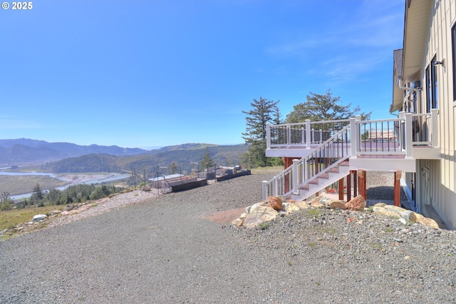 95660 Spirit Ridge Rd, Gold Beach, OR 97444 - view of side of home featuring stairs and a deck with mountain view