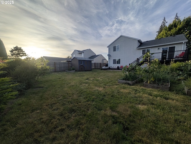 33874 NE Erin Dr, Scappoose, OR 97056 - fenced backyard featuring a shed, a vegetable garden, and a deck