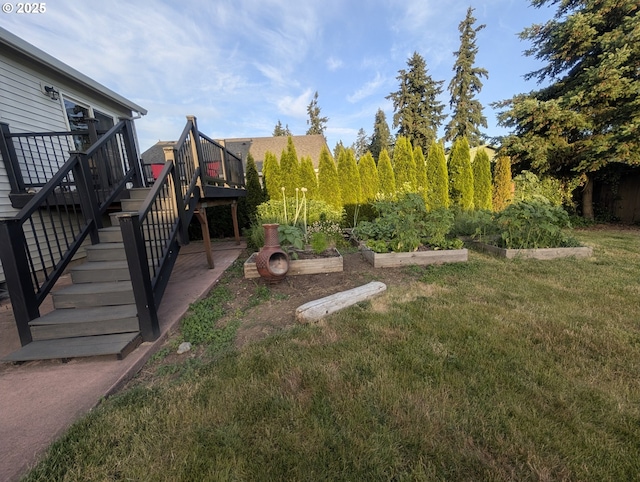33874 NE Erin Dr, Scappoose, OR 97056 - view of grassy yard featuring a vegetable garden, stairway, and a wooden deck