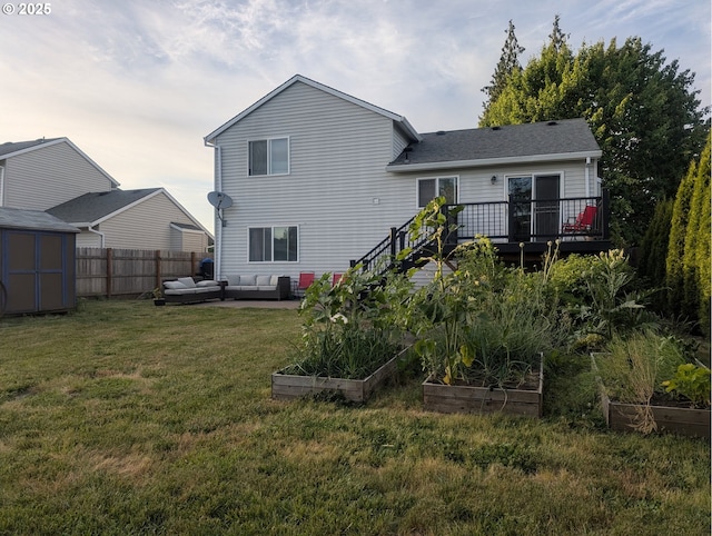 33874 NE Erin Dr, Scappoose, OR 97056 - rear view of property featuring an outdoor living space, a vegetable garden, a shed, and a wooden deck