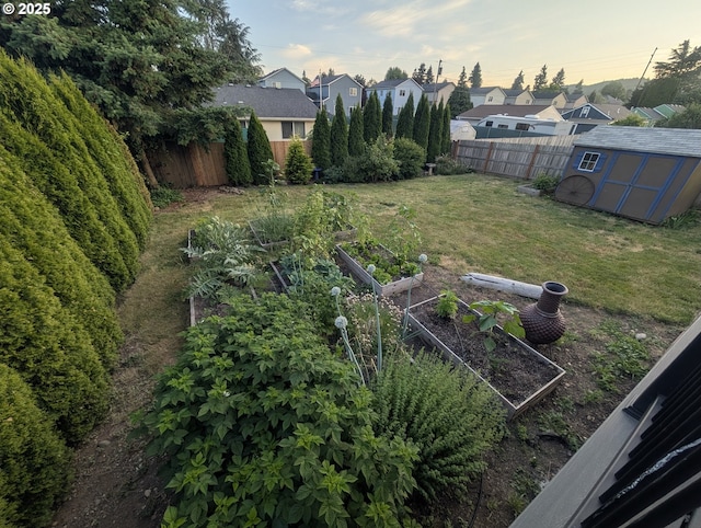 33874 NE Erin Dr, Scappoose, OR 97056 - fenced backyard with a garden, a storage unit, and a residential view