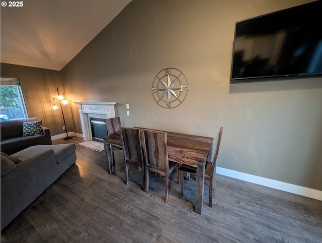 33874 NE Erin Dr, Scappoose, OR 97056 - dining space featuring wood finished floors, a fireplace, and vaulted ceiling
