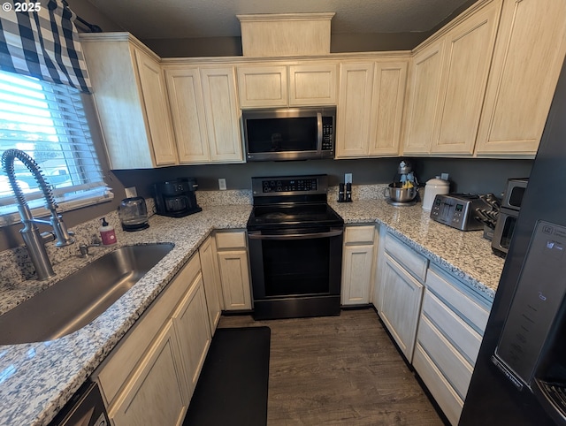 33874 NE Erin Dr, Scappoose, OR 97056 - kitchen with black appliances, dark wood-style flooring, and light stone countertops