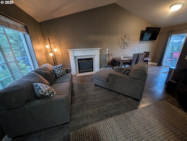 33874 NE Erin Dr, Scappoose, OR 97056 - living room with vaulted ceiling, healthy amount of natural light, wood finished floors, and a fireplace