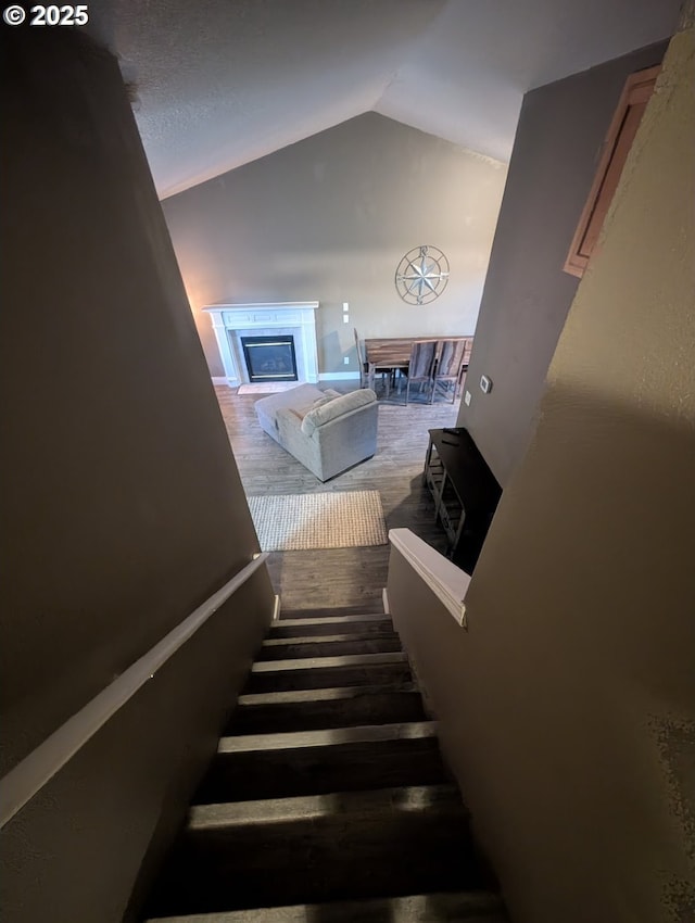 33874 NE Erin Dr, Scappoose, OR 97056 - stairway featuring lofted ceiling and a glass covered fireplace