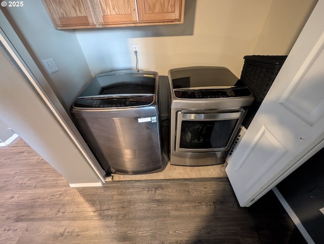 33874 NE Erin Dr, Scappoose, OR 97056 - laundry view of washing machine and clothes dryer and wood finished floors