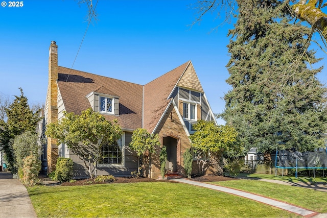 tudor house with a trampoline and a front yard