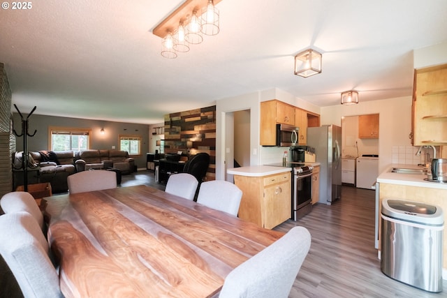 40325 Upper Calapooia Dr, Sweet Home, OR 97386 - dining room with light wood-type flooring and washing machine and clothes dryer