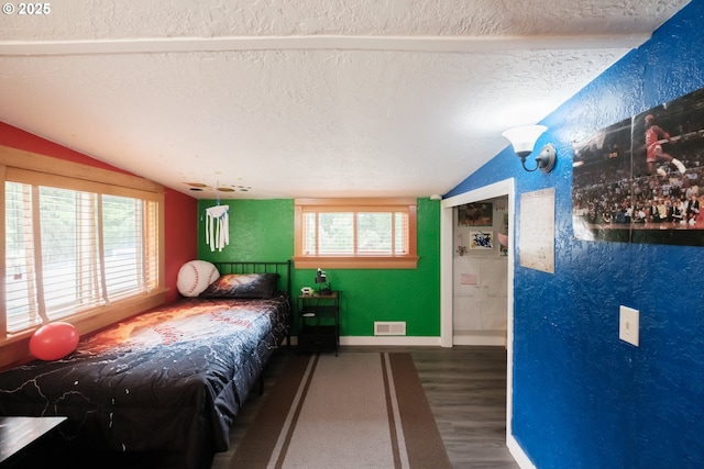 40325 Upper Calapooia Dr, Sweet Home, OR 97386 - bedroom with lofted ceiling, a textured ceiling, wood finished floors, and a textured wall