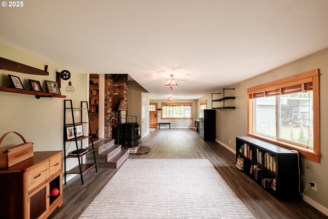 40325 Upper Calapooia Dr, Sweet Home, OR 97386 - unfurnished living room with dark wood-type flooring, stairway, and a chandelier