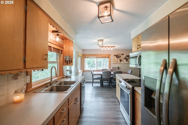 40325 Upper Calapooia Dr, Sweet Home, OR 97386 - kitchen featuring stainless steel appliances, dark wood-style flooring, a textured ceiling, and light countertops