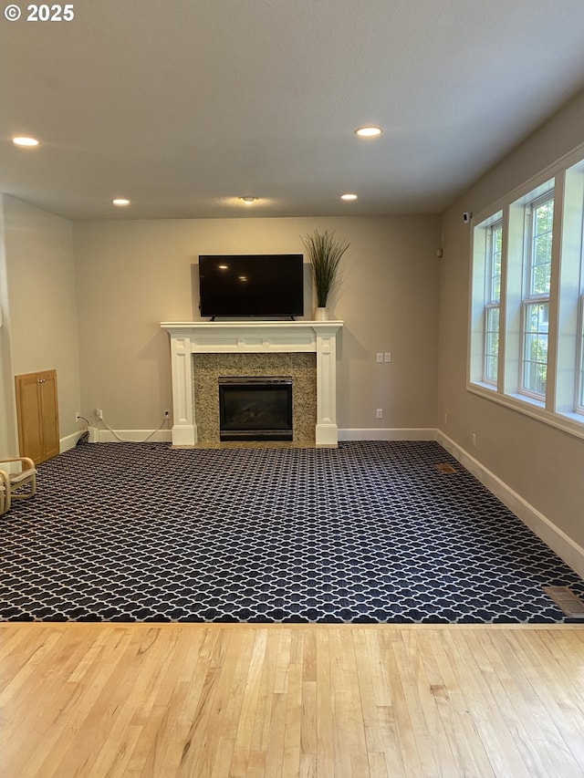 9587 NW Caxton Ln, Portland, OR 97229 - unfurnished living room with wood finished floors, recessed lighting, and a premium fireplace