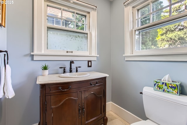 5536 N Delaware Ave, Portland, OR 97217 - bathroom with baseboards, plenty of natural light, vanity, and toilet