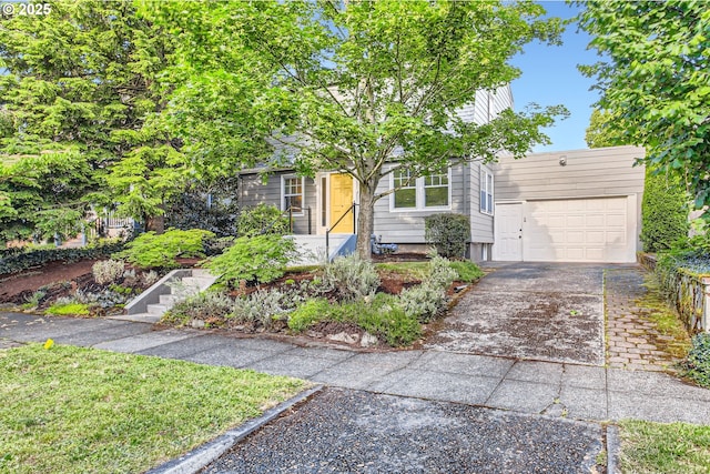 5536 N Delaware Ave, Portland, OR 97217 - view of property hidden behind natural elements with concrete driveway and an attached garage