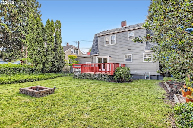 5536 N Delaware Ave, Portland, OR 97217 - rear view of house with an outdoor fire pit, a deck, a yard, and a chimney