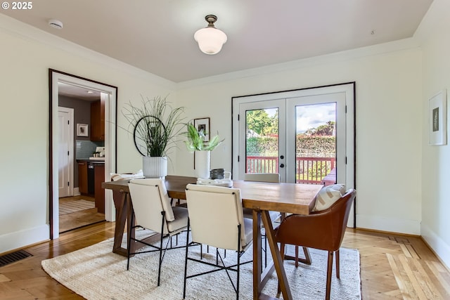 5536 N Delaware Ave, Portland, OR 97217 - dining space with french doors, baseboards, crown molding, and light wood-type flooring
