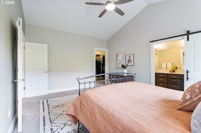 carpeted bedroom with a walk in closet, high vaulted ceiling, baseboards, a closet, and ensuite bathroom