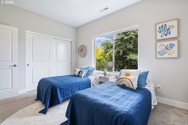 bedroom featuring carpet, a closet, and baseboards