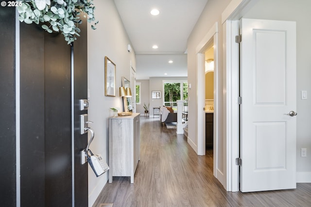 entrance foyer featuring wood finished floors, recessed lighting, and baseboards